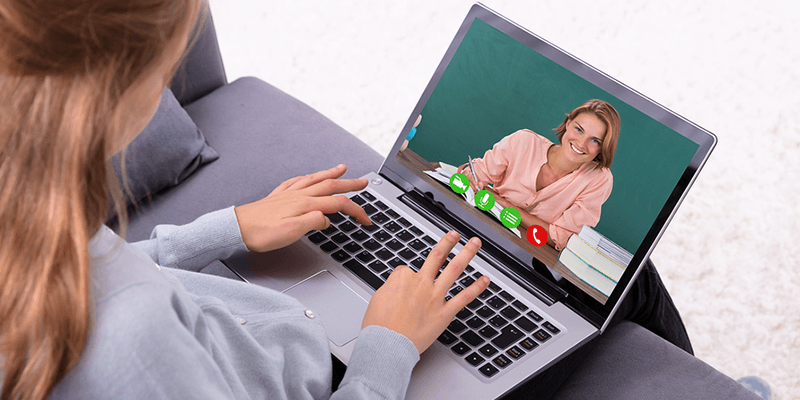 Teacher on laptop screen with woman watching