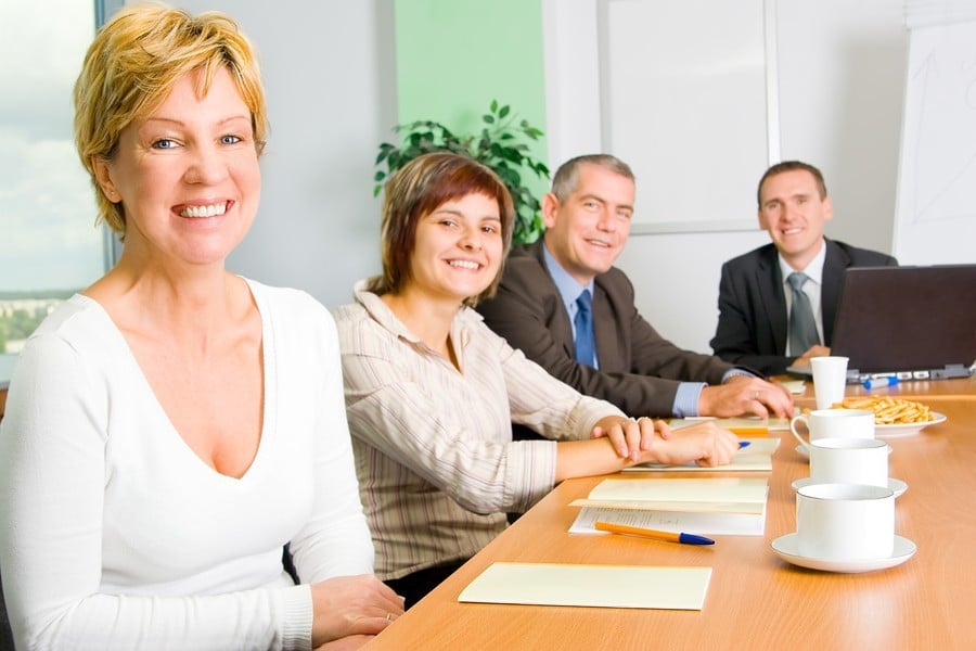 2 women and 2 men sitting at a conference table
