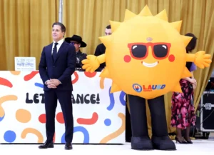Los Angeles Unified Supt. Alberto Carvalho, left, waits with an LAUSD mascot during the official launch of Ed, a new district-developed, AI-assisted learning tool.