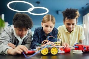 Three children working together at a table.