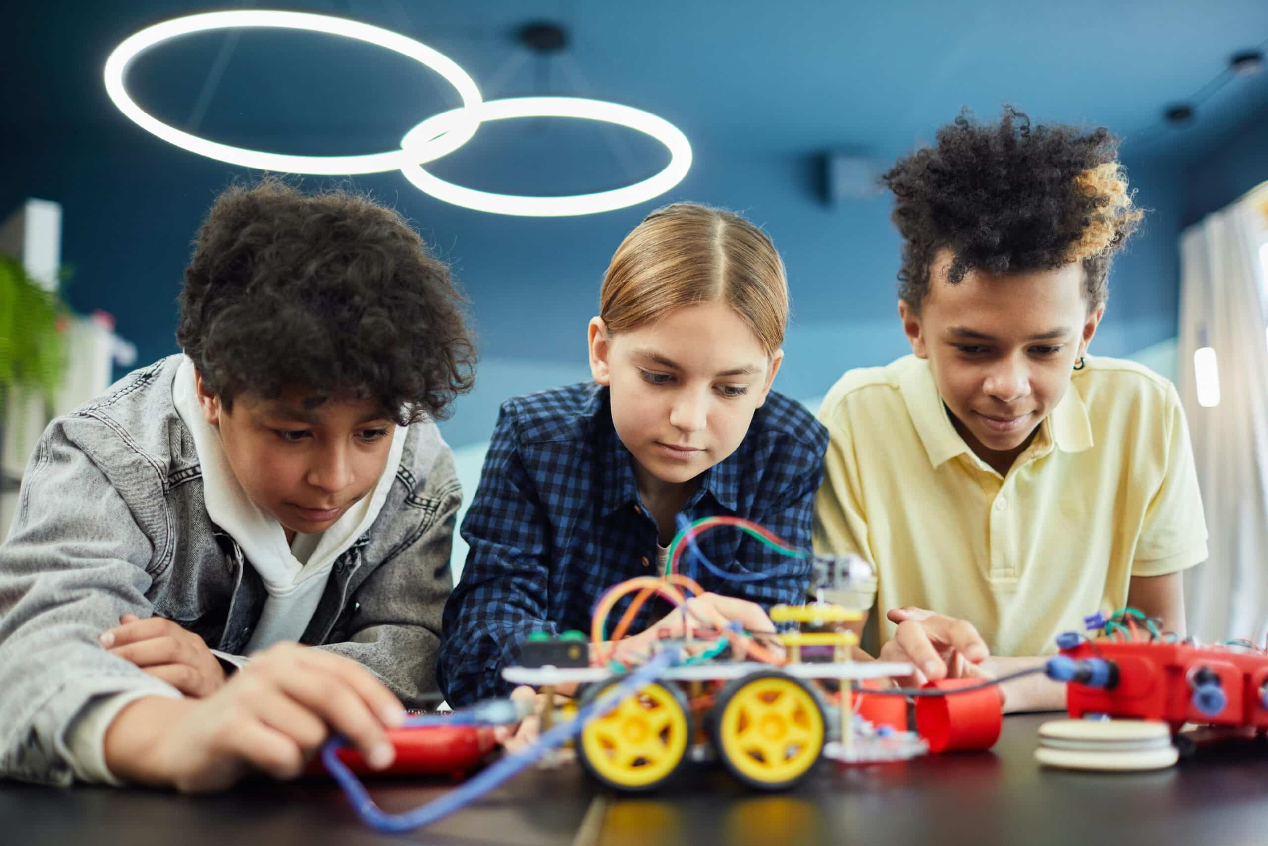 Three children working together at a table.