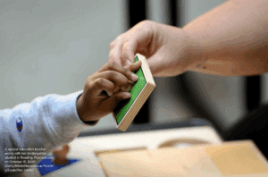 IDEA at 50 graphic: A special education teacher works with her kindergarten student in Reading, Pennsylvania, on October 15, 2020. (Getty/MediaNewsGroup/Reading Eagle/Ben Hasty)